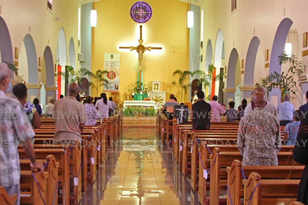 Church goers observe covid19 protocols at Our Lady Of Perpetual Help RC Church in San Fernando on Sunday morning. - Photo by  Marvin Hamilton