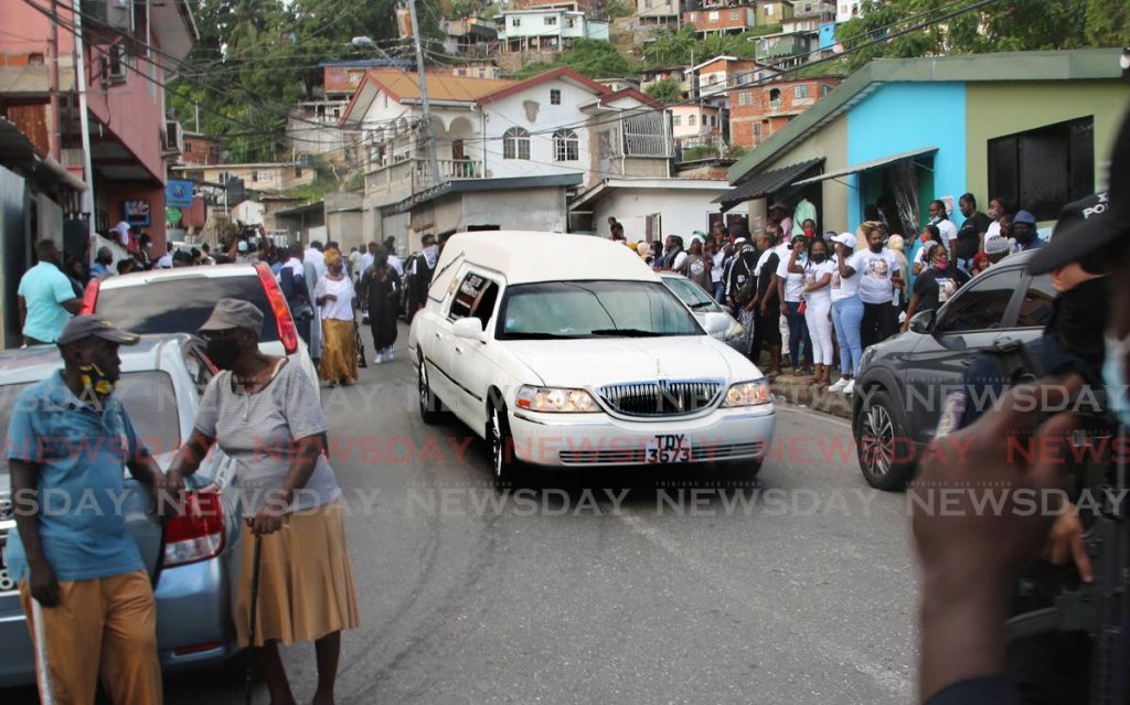 LAST JOURNEY: The hearse leaves the basketball court in John John, Laventille with the body of murdered reputed gang leader Anthon 