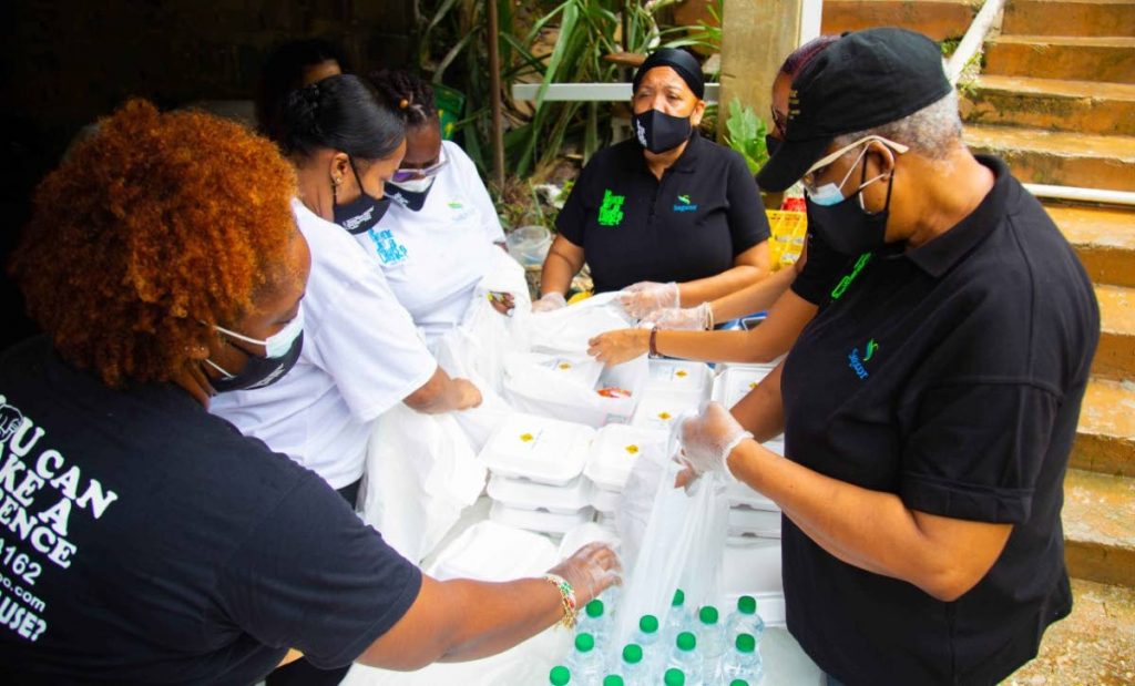 Sagicor and ITNAC (Is There Not A Cause) team up to  deliver meals to a community in Carenage. - 