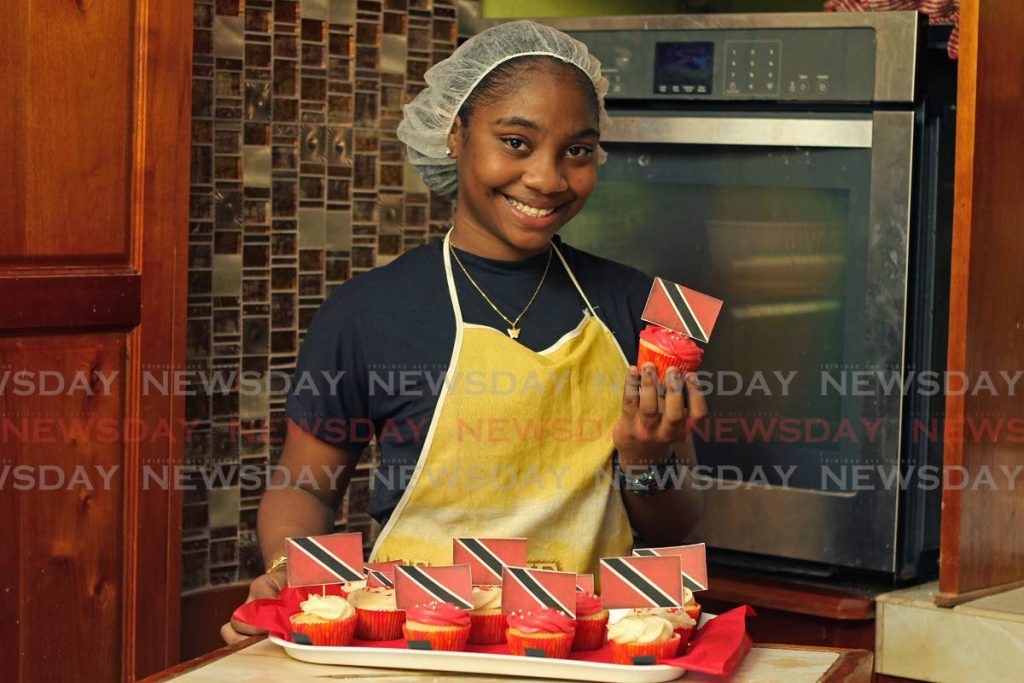 Shermia Pierre, owner of Mia Magical Designs, baked cup cakes topped with the national flag at her home in Mayaro. - Photo by Marvin Hamilton