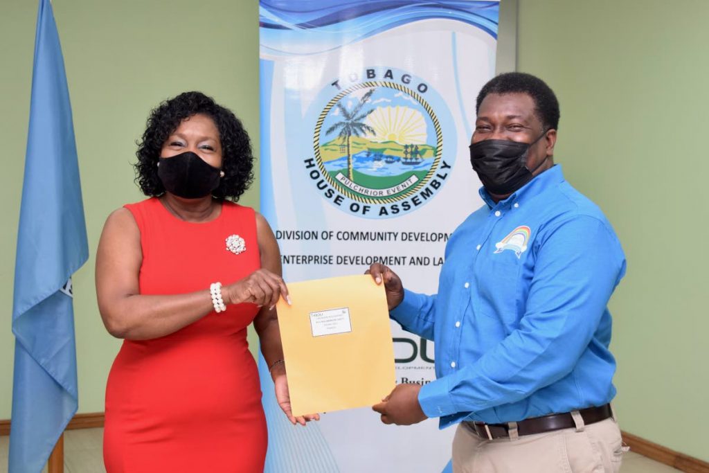 THA Secretary of Community Development, Enterprise Development and Labour Assemblyman Marslyn Melville-Jack distributes one of the cheques a delighted recipient.  - THA PHOTOS 