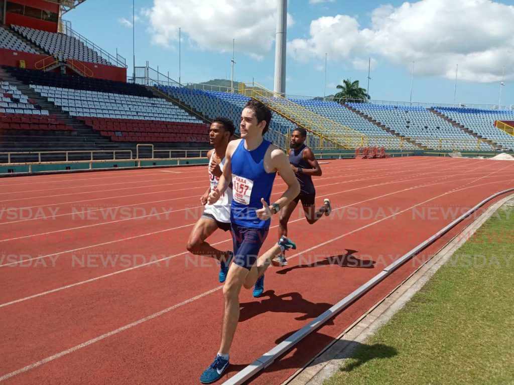 Stephon Gould of Richard Jones Racing, left, and Troy Llanos of Fatima College, middle, compete in the men's Under-23 1,500m event at the Pan Amercian Under-20 and Pan American Under-23 preparation meet at the Hasely Crawford Stadium in Port of Spain, on Sunday.  - Photo by Jelani Beckles