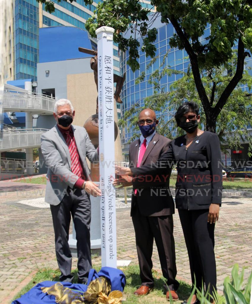 To commemorate International Day of Peace,the Rotary Club of Central Port of Spain unveil a Peace Pole on the Brain Lara Promenade in photo for the ceremony from left Port of Spain Mayor Joel Martinez, the Rotary Club President Percy Parker Williams and member Debbie Roopchand. - Photo by Sureash Cholai