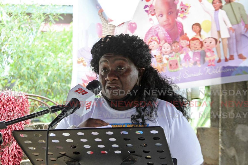 Michelle Williams speaks at the funeral of her one-year-old granddaugher Sariah at the family home in Tarodale on Saturday. - Photo by Marvin Hamilton