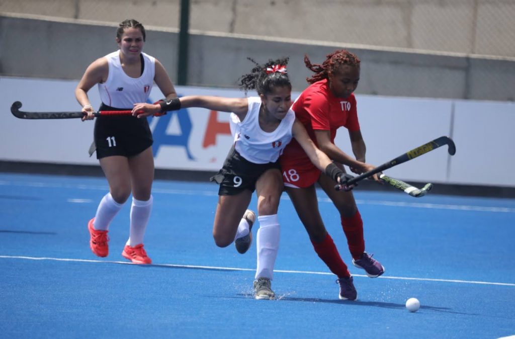 Trinidad and Tobago's Daniella Cabralis, right, in action against Peru in the Pan Am Challenge on Sunday in Lima, Peru. PHOTO COURTESY Pan Am Hockey  - 
