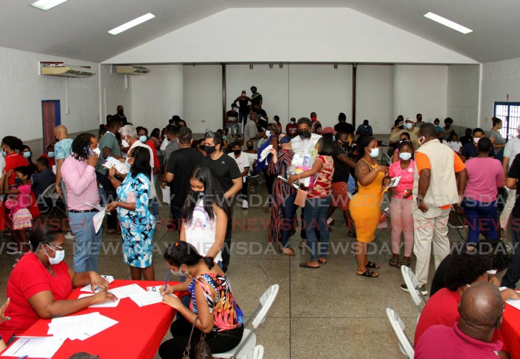 People wait to be vaccinated at St Joseph Community Centre, Market Street, St Joseph on Sunday during an exercise arranged by Health Minister Terrence Deyalsingh, the MP, and the St Joseph RC Church. Photo by Ayanna Kinsale