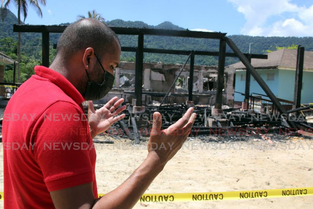 Asha's Bake & Shark, director Mark Tulsie raised his hands in anguish outside his business on the  Maracas Bay beachfront. The establishment was completely destroyed by fire. - Photo by Sureash Cholai