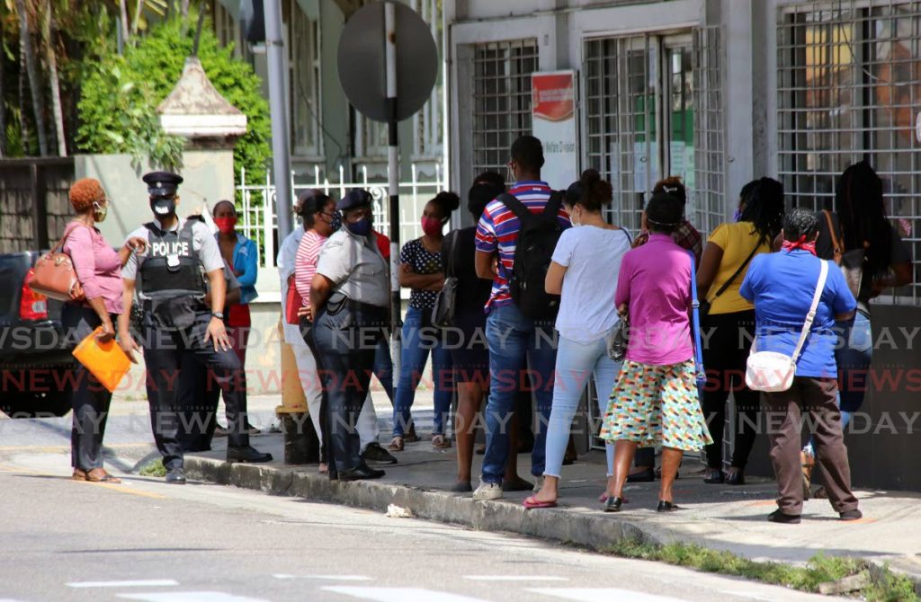 A long line of people waiting for covid19 relief grants at the Ministry of Social Development and Family Services in Port of Spain. - Photo by Sureash Cholai