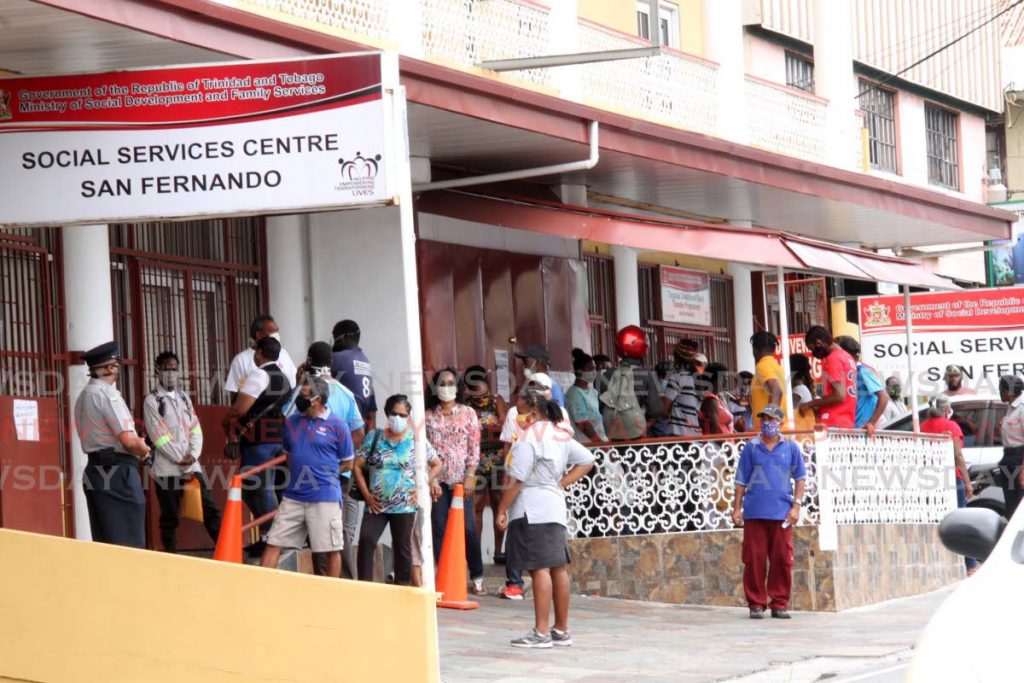 Scores of people wait outside  the Social Services Centre, San Fernando to receive covid19 relief grants. - File photo