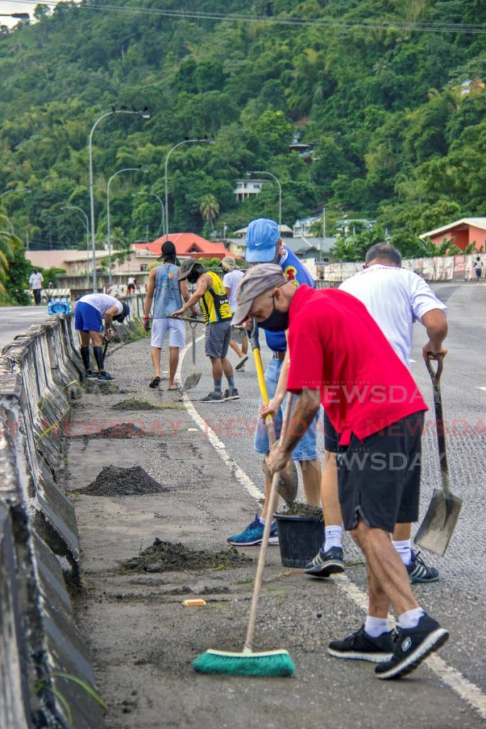 Volunteers helps to clean a section of the Diego Martin Highway. Photo by Melanie Waithe - 