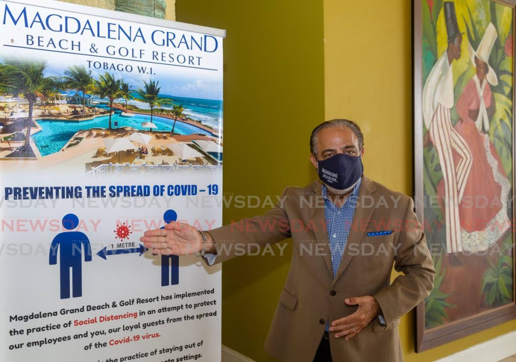 Magdalena Grand Beach and Golf Resort general manager Vinod Bajaj shows one of the signs in place at the hotel to prevent the spread of covid19.  - DAVID REID 