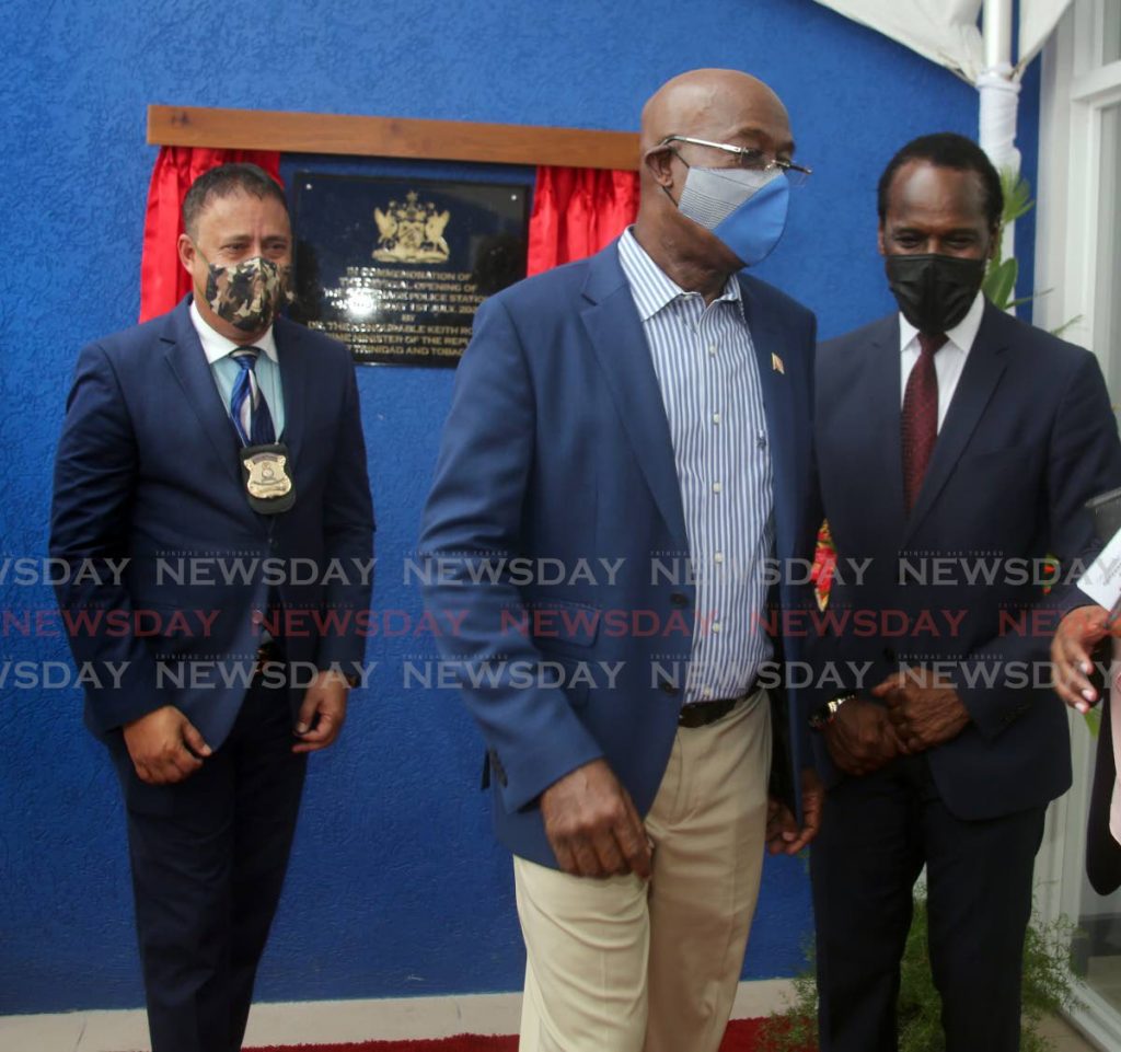 Prime Minister Dr Keith Rowley chats with National Security Minister Fitzgerald Hinds, alongside then police commissioner Gary Griffith, at the opening of the Carenage Police Station on July 1. - PHOTO BY SUREASH CHOLAI