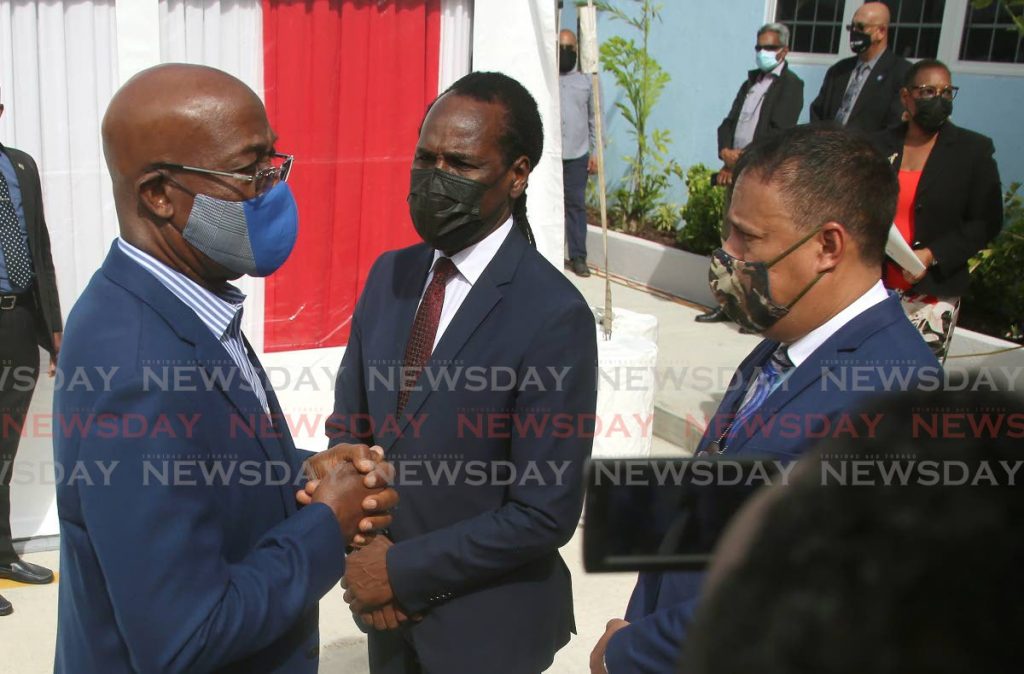 Prime Minister Dr Keith Rowley, left, faces then police commissioner Gary Griffith alongside National Security Minister Fitzgerald Hinds at the opening of the Carenage Police Station on July 1. - Photo by Sureash Cholai