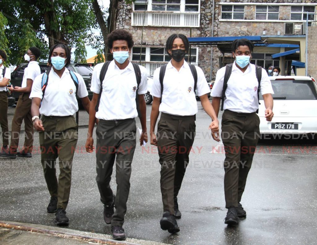 In this file photo, masked Presentation College students leave the San Fernando school after CXC exams on July 7. - Photo by Ayanna Kinsale