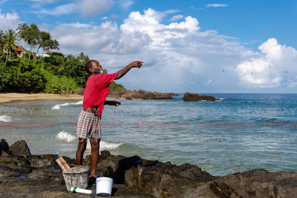 Dexter Thomas throws a fishing line on a beach in Tobago. Prime Minister Dr Keith Rowley on Friday vowed that the Marriott hotel development at Rocky Point will comes to pass. - File photo/David Reid