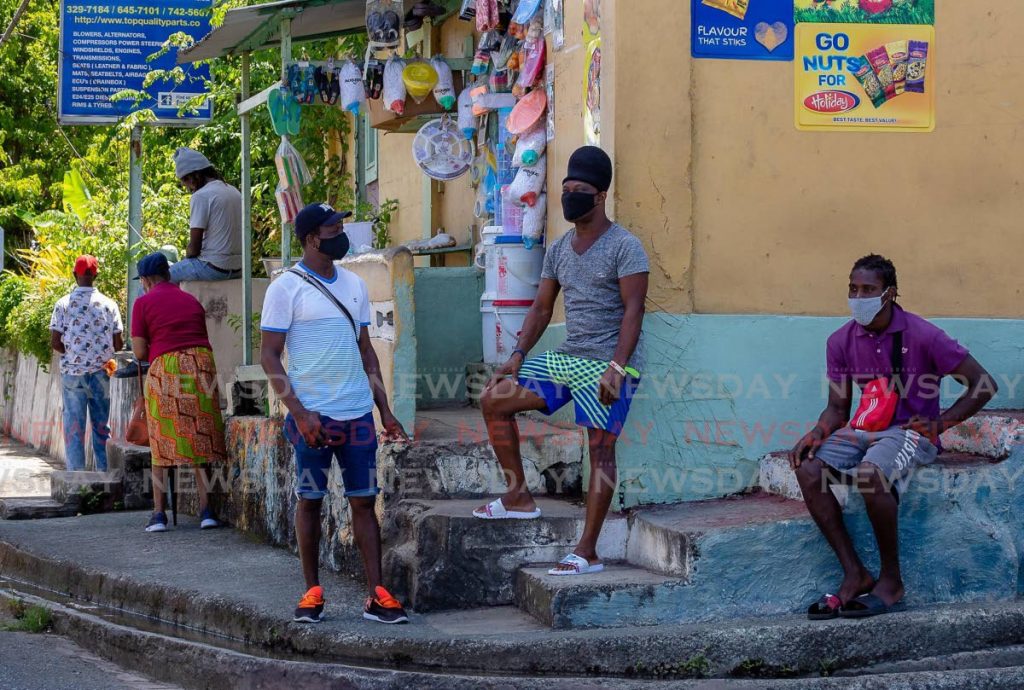 Three men relax at Patience Hill Junction last month. Patience Hill is one of the 15 electoral districts for the December 6 THA election. - Photo by David Reid