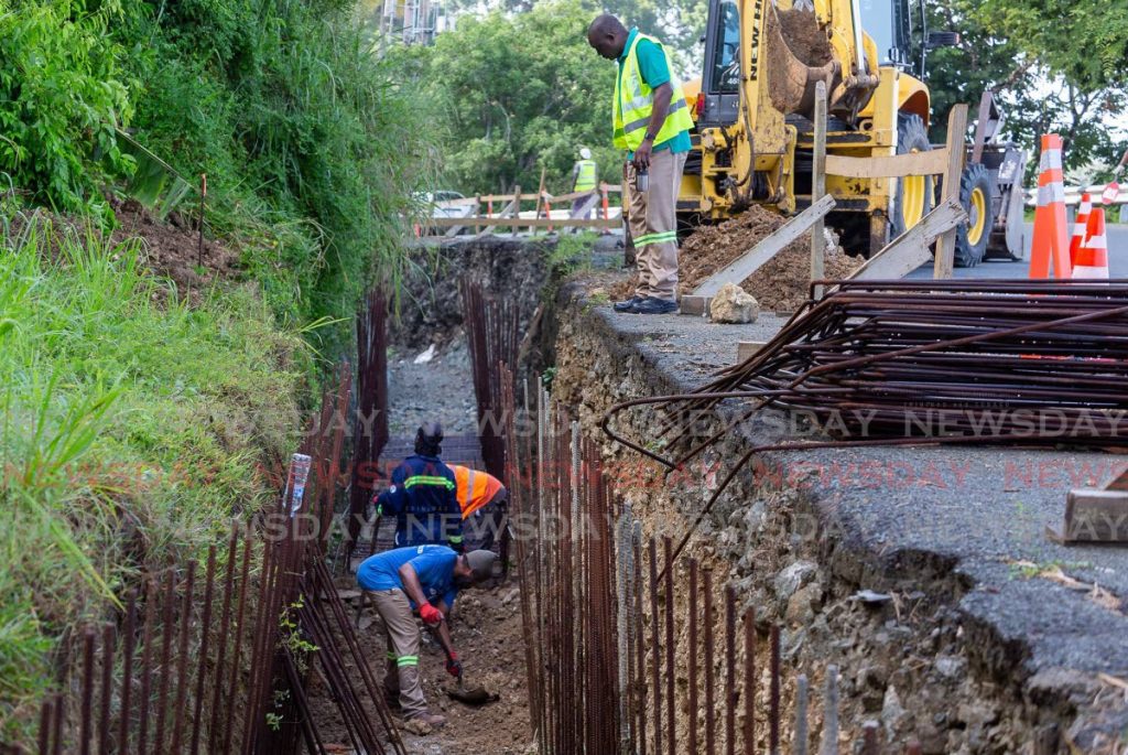 In this September file photo, workers from the Division of Infrastructure, Quarries and the Environment clear debris before placing steel at a drainage project in Mt Irvine recently. FILE PHOTO - 