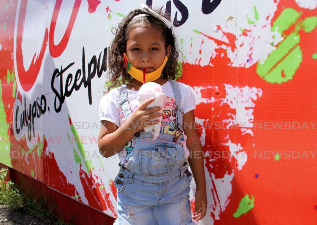 Javiannys Figuera enjoys a snowcone to cool the heat at Queen's Park Savannah, Port of Spain. - Photo by Ayanna Kinsale