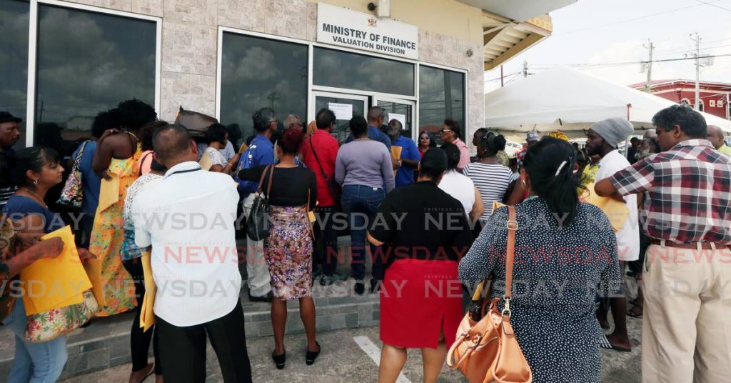 In this 2017 file photo, people crowd the entrance of the Ministry of Finance’s valuation office at Caroni Savannah Road, Charlieville to submit requested documents for property tax valuation.  