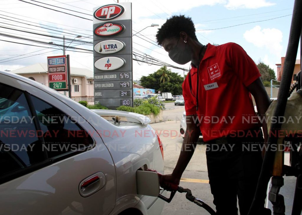 An attendant pumps gas into a vehicle’s tank at St Christopher's service station on Wrightson Road, Port of Spain. As government pushes ahead with plans to liberalise the fuel market, Finance Minister Colm Imbert announced in his 2022 Budget speech that fuel cash cards would be made available to vulnerable groups.  - Photo by Ayanna Kinsale