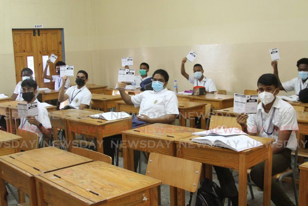 In this file photo, Presentation College San Fernando students display their immunisation cards in their classroom on October 4, the first day vaccinated forms four to six students were allowed back into the classrooms. - Marvin Hamilton