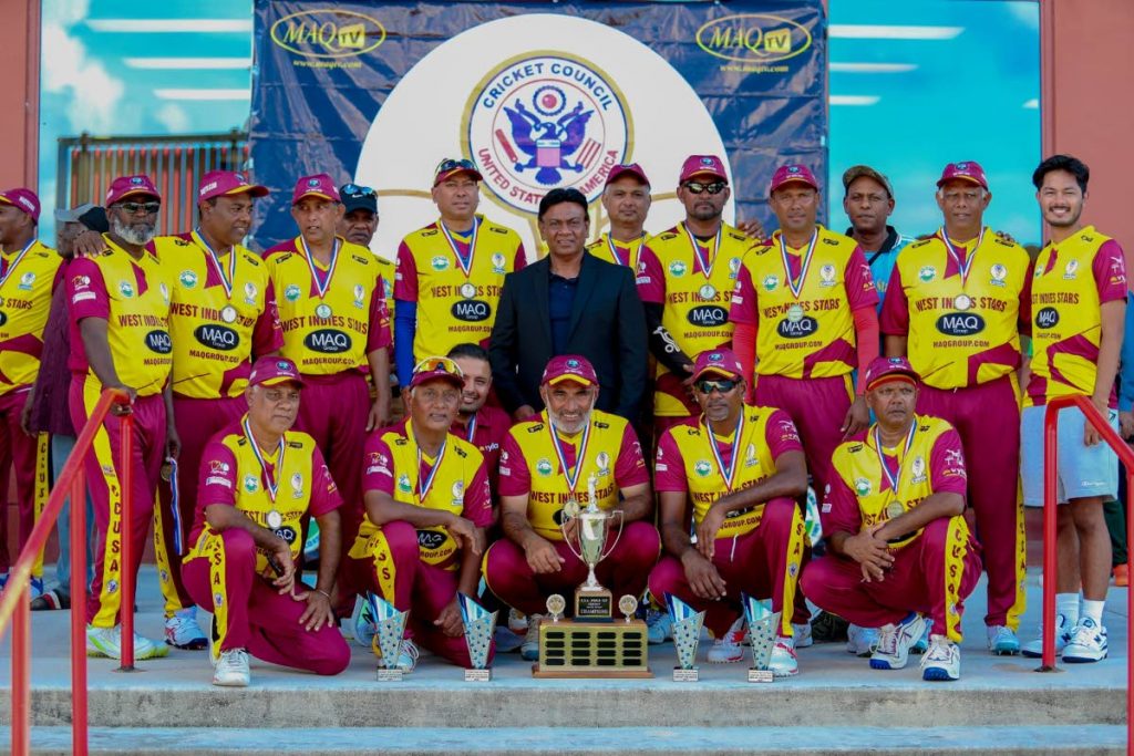 The triumphant West Indies team with chairman of CCUSA Mahammad Qureshi (in black). - 