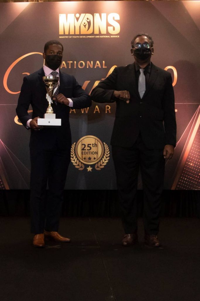 Olympic cyclist Kwesi Browne, left, with his National Youth Award for Community Sport (18-35).  - Ministry of Youth Development and National Service