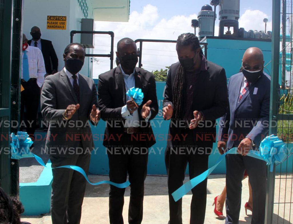 BLUE RIBBON EVENT: Public Utilities Minister Marvin Gonzales, 2nd from left, cuts the ribbon on Wednesday to formally open the refurbished WASA booster station in Pitch Road, Morvant. Also in photo from left are Laventille West MP Fitzgerald Hinds, Laventille East/Morvant MP Adrian Leonce and WASA CEO Sherland Sheppard. PHOTO BY ROGER JACOB - 