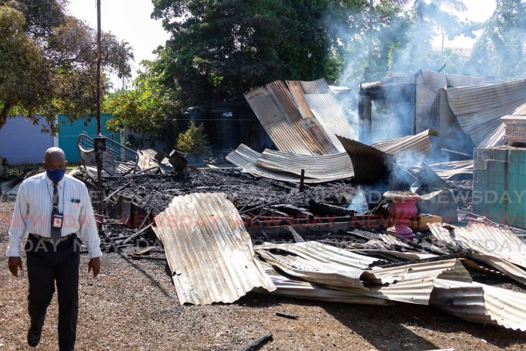 Fire officers were at the scene on Monday to investigate the cause of a Sunday night blaze which destroyed a house and car at Store Bay Branch Road, Bon Accord . - David Reid