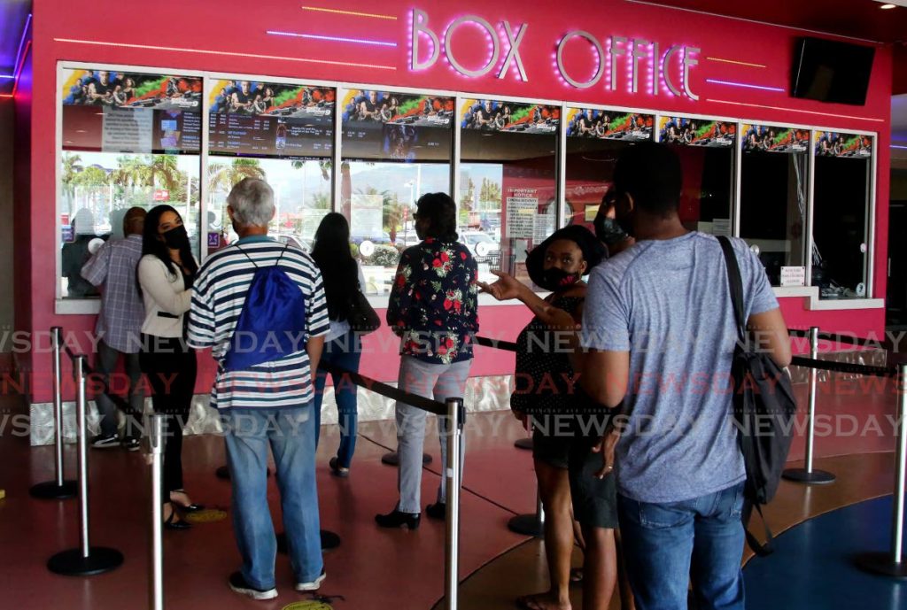 In this October 12 file photo, customers wait in line to buy their tickets at MovieTowne, Port of Spain as cinimas were re-opened as safe zones. Photo by Sureash Cholai