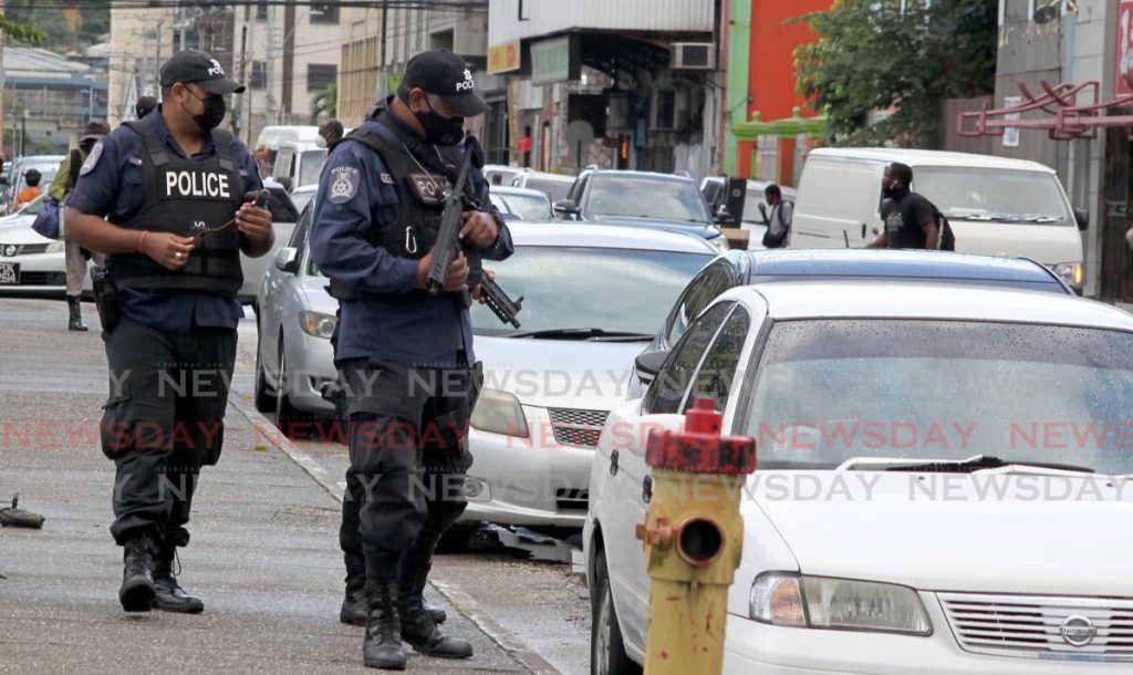 In this file photo, police on patrol question a driver on Independence Square, Port of Spain. 