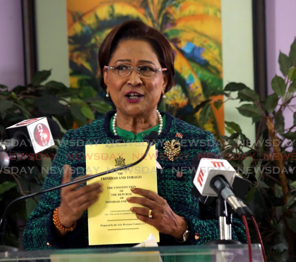 Opposition Leader Kamla Persad-Bissessar holds a copy of the Constitution at a news conference held at the Office of the Opposition Leader in Port of Spain. - PHOTO BY SUREASH CHOLAI
