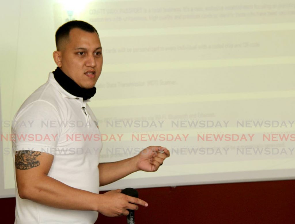 Elliot Chin, owner of Elliot Chin Executive Services (ECES), explains how his proposed vaccination e-cards works at the School of Practical Accounting, Chaguanas on Friday. - Photo by Ayanna Kinsale