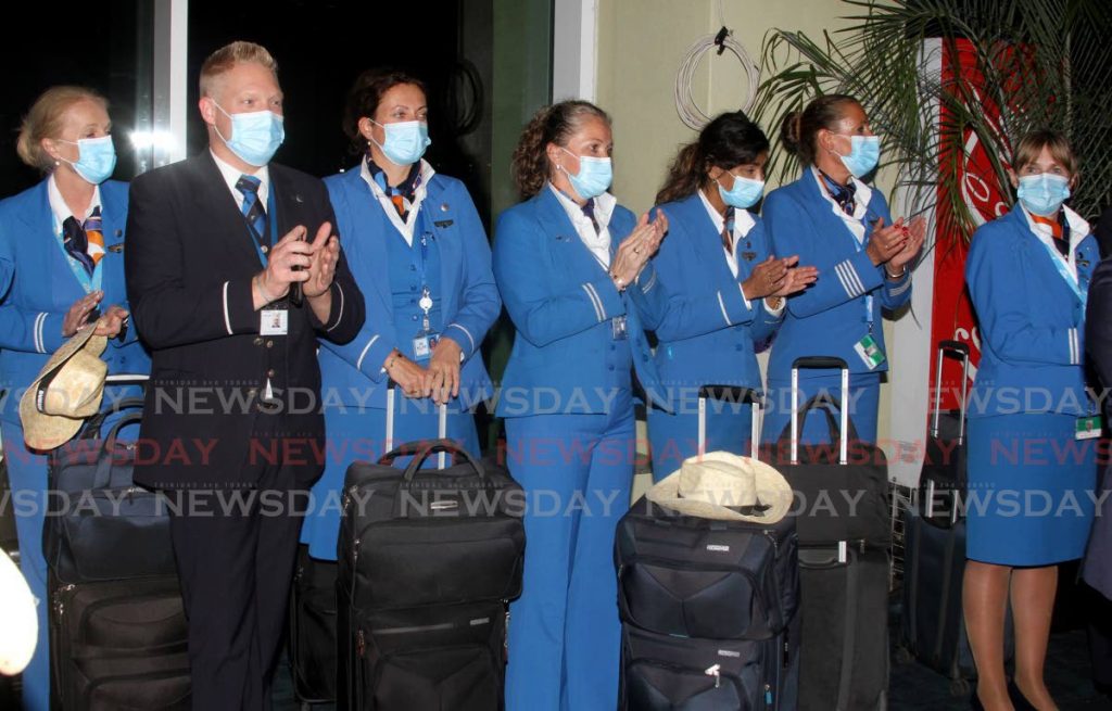 WELCOME BACK: KLM Royal Dutch Airlines staff applaud at a function held in their honour at the Piarco International Airport on Saturday when the airline made its inaugural flight on its return to TT after two decades.  - Photo by Angelo Marcelle