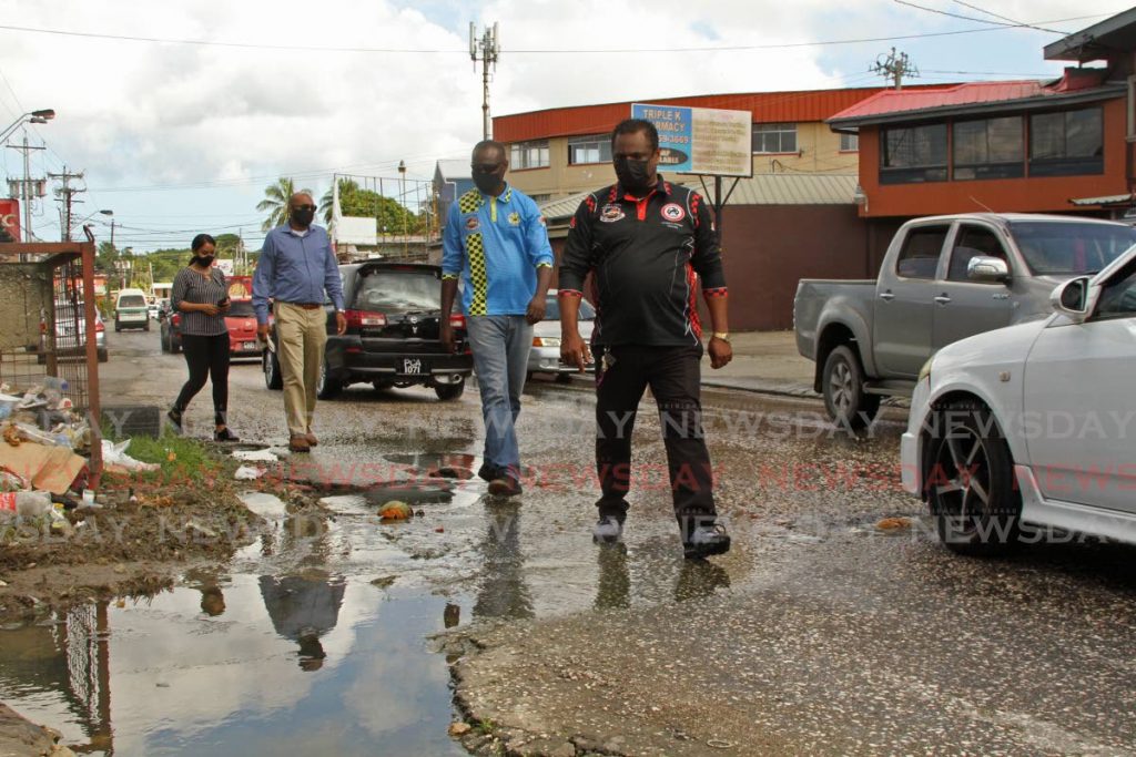 President of Macaulay Taxi Drivers Association Haimraj Narine, front, leads representatives from the Ministry of Works and Transport on a tour of roads in Claxton Bay and environs on Monday. - Marvin Hamilton