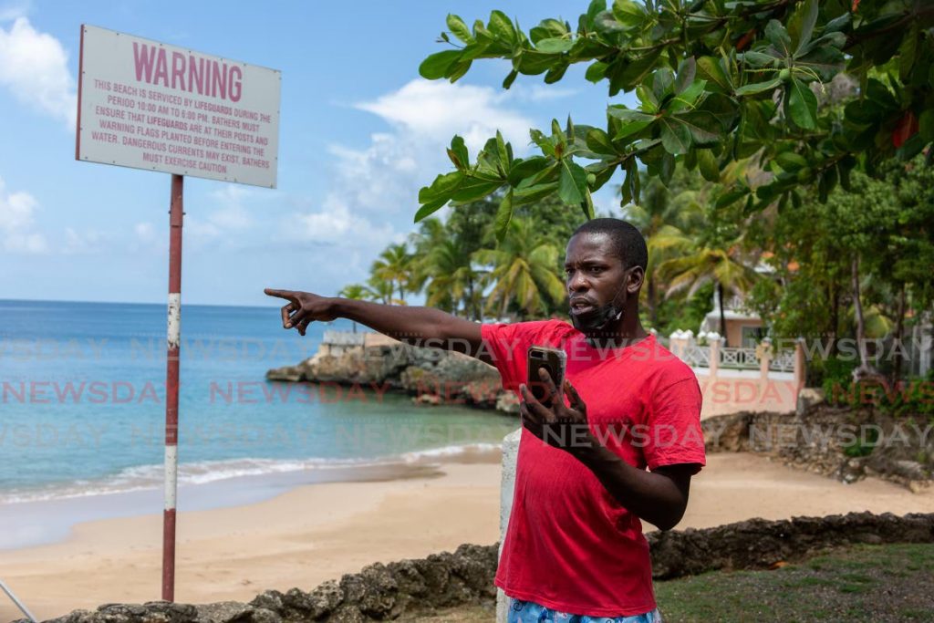 Fisherman Romell Rivers points to where a waterspout developed over Store Bay on Monday morning. - Photo by David Reid