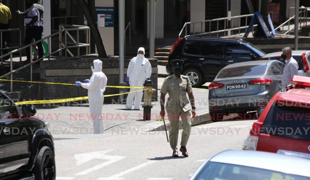 CORDONED OFF: Police and crime scene officers at the parkade of the Government Campus in Port of Spain on Monday following an explosion. PHOTO BY SUREASH CHOLAI - 