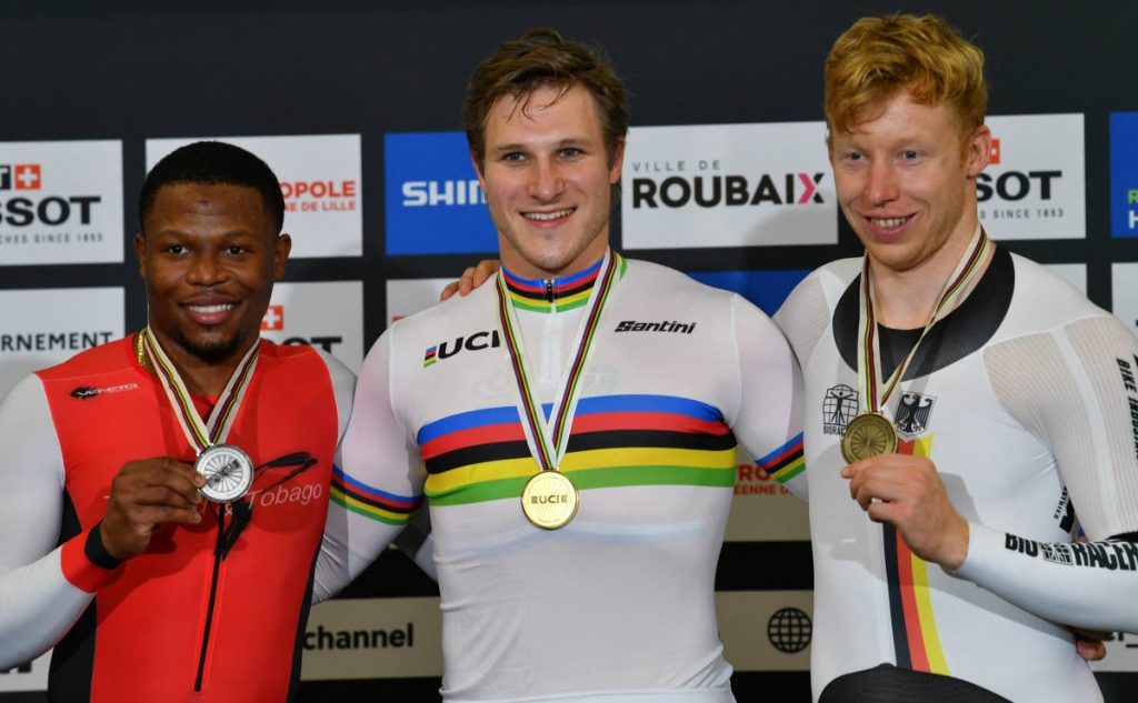 Silver medallist Trinidad and Tobago's Nicholas Paul (left), gold medallist Netherlands' Jeffrey Hoogland (centre) and bronze medallist Germany's Joachim Eilers celebrate on the podium after the men's 1Km Time Trial final during the UCI Track Cycling World Championships at The Jean-Stablinski Velodrome in Roubaix, France, on Friday. (AFP PHOTO) - 
