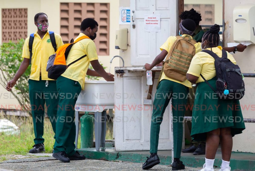 In this file photo Signal Hill Secondary students wash their hands as they enter the school compound.  Photo by David Reid