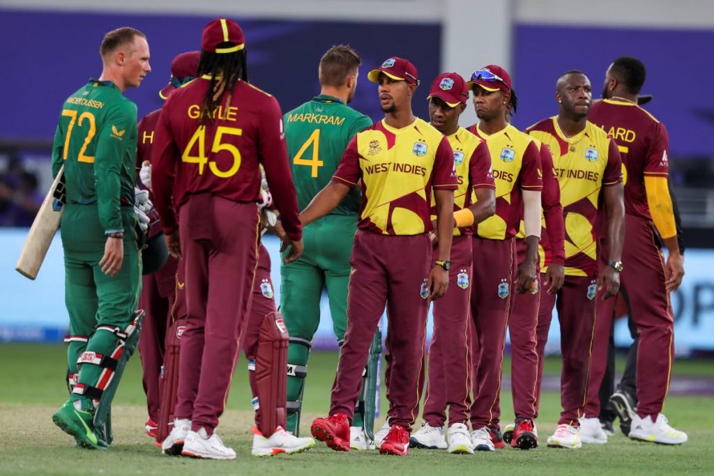 West Indies players, right, congratulate South Africa's Rassie van der Dussen, left, and Aiden Markram following their Twenty20 World Cup match in Dubai, UAE, on Tuesday. - 