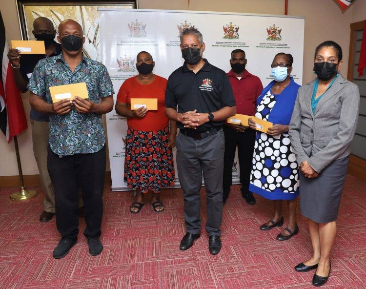 Agriculture Minister Clarence Rambharat with farmers during a lease distribution ceremony on Tuesday at the Agriculture Ministrys head office in Chaguanas.  - Ministry of Agriculture, Land and Fisheries