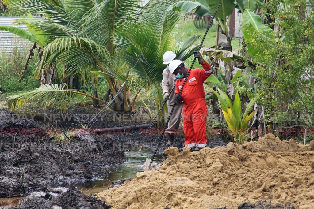 Workers continue cleanup efforts after a Heritage oil pipeline ruptured along Well Road, off Agapito trace Santa Flora. - Lincoln Holder