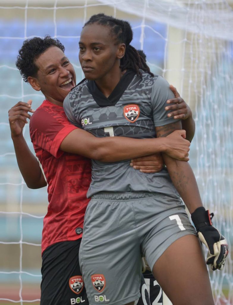 TT women’s team defender Lauryn Hutchinson hugs goalkeeper Kimika Forbes after she saved a penalty against Panama, at the Ato Boldon Stadium, Couva, on Monday.  - via TTFA Media 
