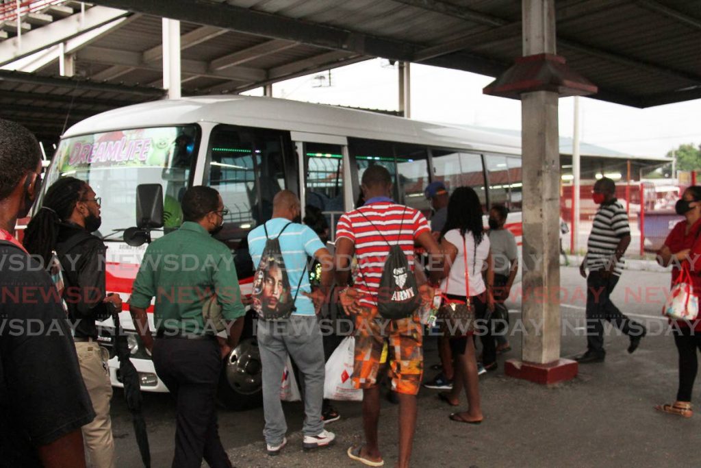 Passengers enter an Arima maxi taxi at City Gate Port of Spain on Thursday. Photo by Angelo Marcelle