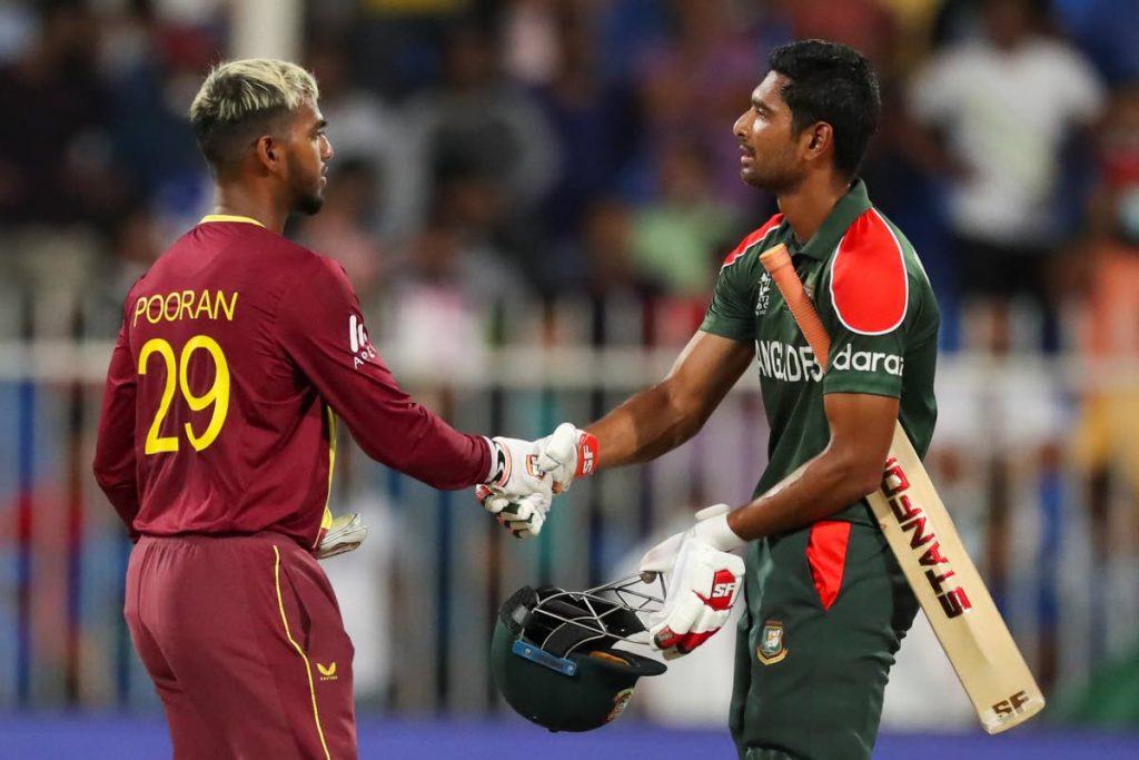 Bangladesh's captain Mohammad Mahmudullah congratulates West Indies' Nicholas Pooran, left, after their Cricket Twenty20 World Cup match in Sharjah, UAE, Friday, Oct. 29, 2021. (AP Photo)
