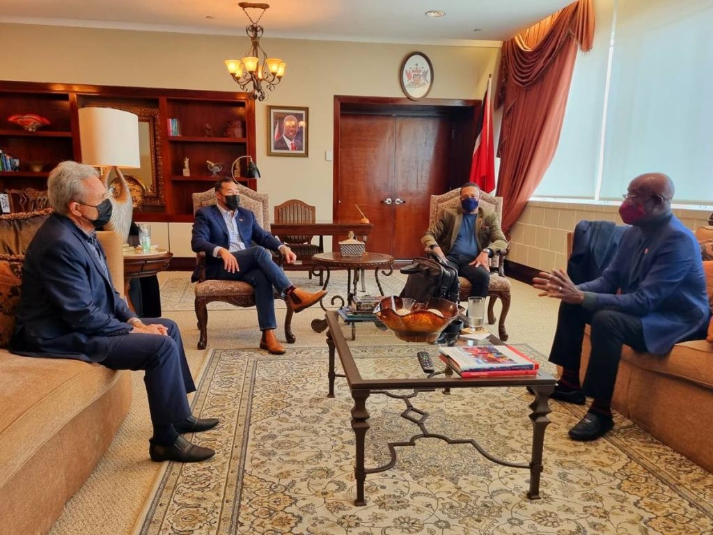 Prime Minister Dr Rowley, right, chats with Finance Minister Colm Imbert shortly before he left for London on Saturday. Also in photo are Energy Minister Stuart Young, second from left, and Foreign Affairs and Caricom Minister Dr Amery Browne who will accompany Rowley. Imbert will act as prime minister until Rowley returns on November 6. - Photo courtesy Office of the Prime Minister