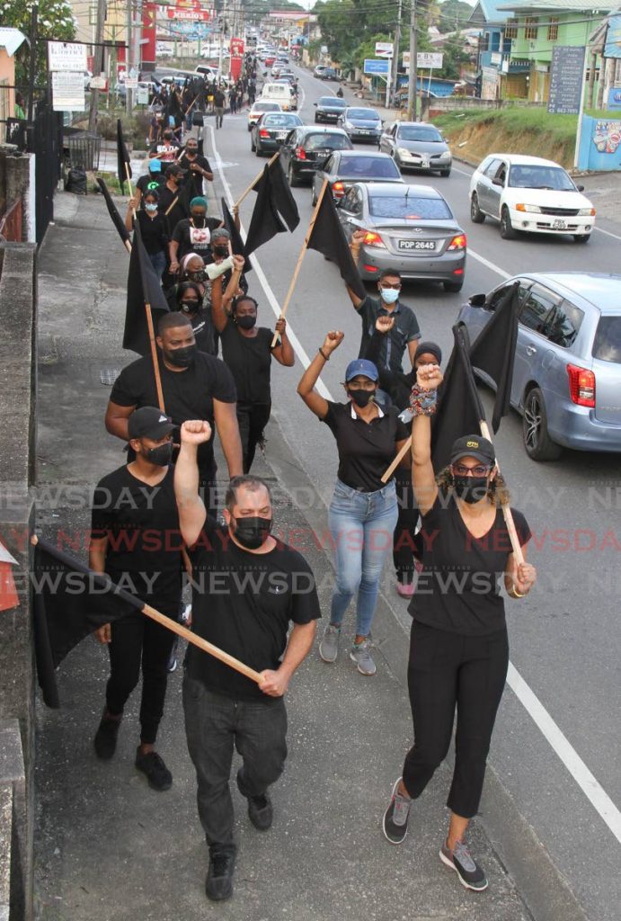 St Augustine MP Khadijah Ameen, right, leads a silent march walk along the Eastern Main Road, El Dorado on Saturday. The walk is part of the UNC's October Revolution.  - Photo by Angelo Marcelle