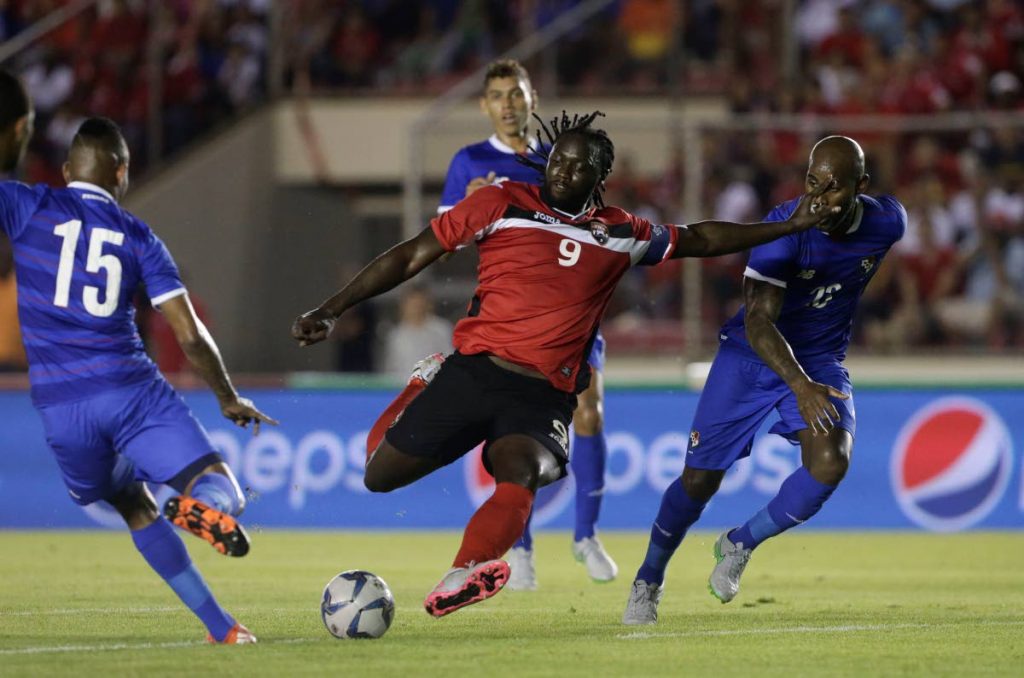 In this file photo, TT captain Kenwyne Jones (centre) shoots against Panama in a friendly in Panama City, on Oct 8, 2015. - AP