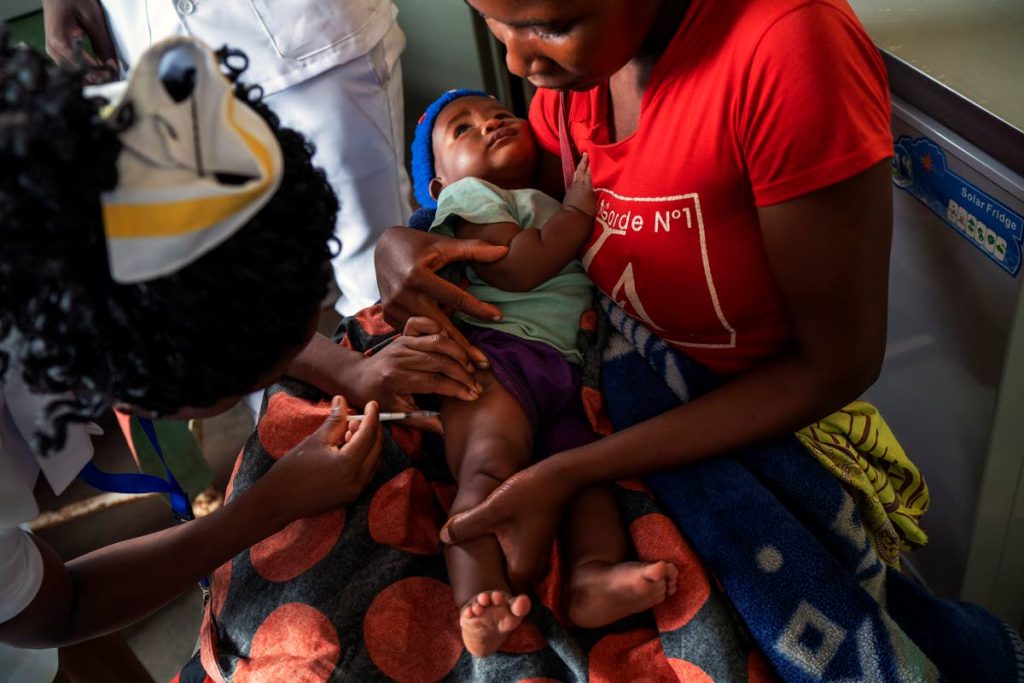 In this photo taken December 10, 2019, residents of the Malawi village of Migowi have their children become test subjects for the world's first vaccine against malaria. AP PHOTO - 