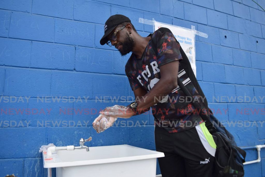 A man washes his hands before leaving the Central Market in Port of Spain in this March 20, 2020 file photo. Global hygiene soap brand Lifebuoy is marking Global Handwashing Day with a planned global virtual classroom to impart the importance of personal hygiene.  - 